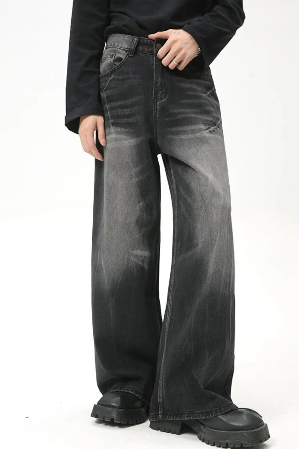 Whiskered wide leg dark wash denim jeans with a relaxed fit and distressed details.