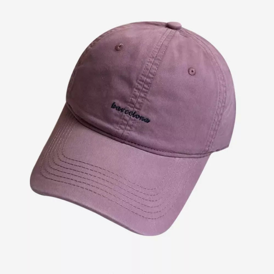 Purple baseball cap with embroidered "barcelona" text and stitched brim.