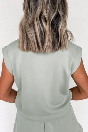 Light green activewear set with padded shoulders and banded hem.
