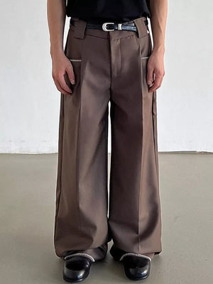 Brown relaxed fit wide-leg pants with decorative zipper trim pockets and a belted waist.