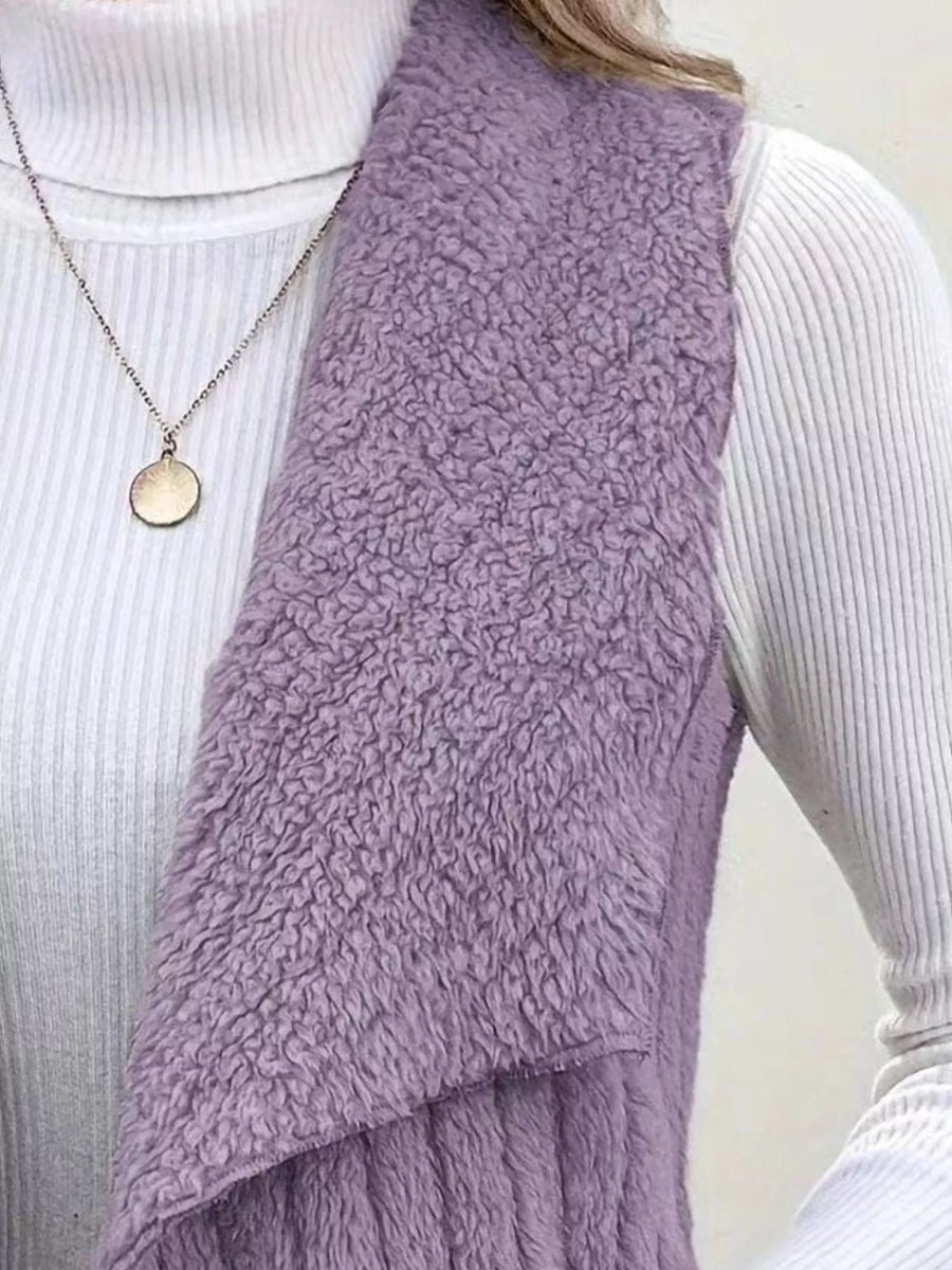 Purple fleece vest with open front, textured material, styled with a white turtleneck and necklace.