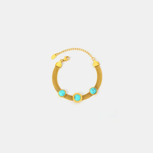 Gold mesh bracelet with three turquoise stones and Roman numerals.