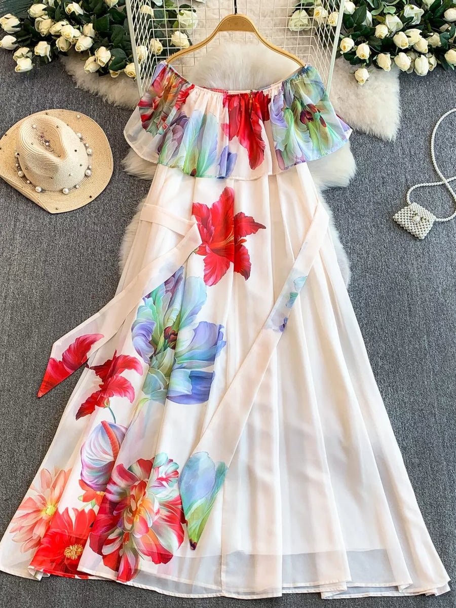 White off-shoulder A-line dress with a vibrant floral print and a matching belt.