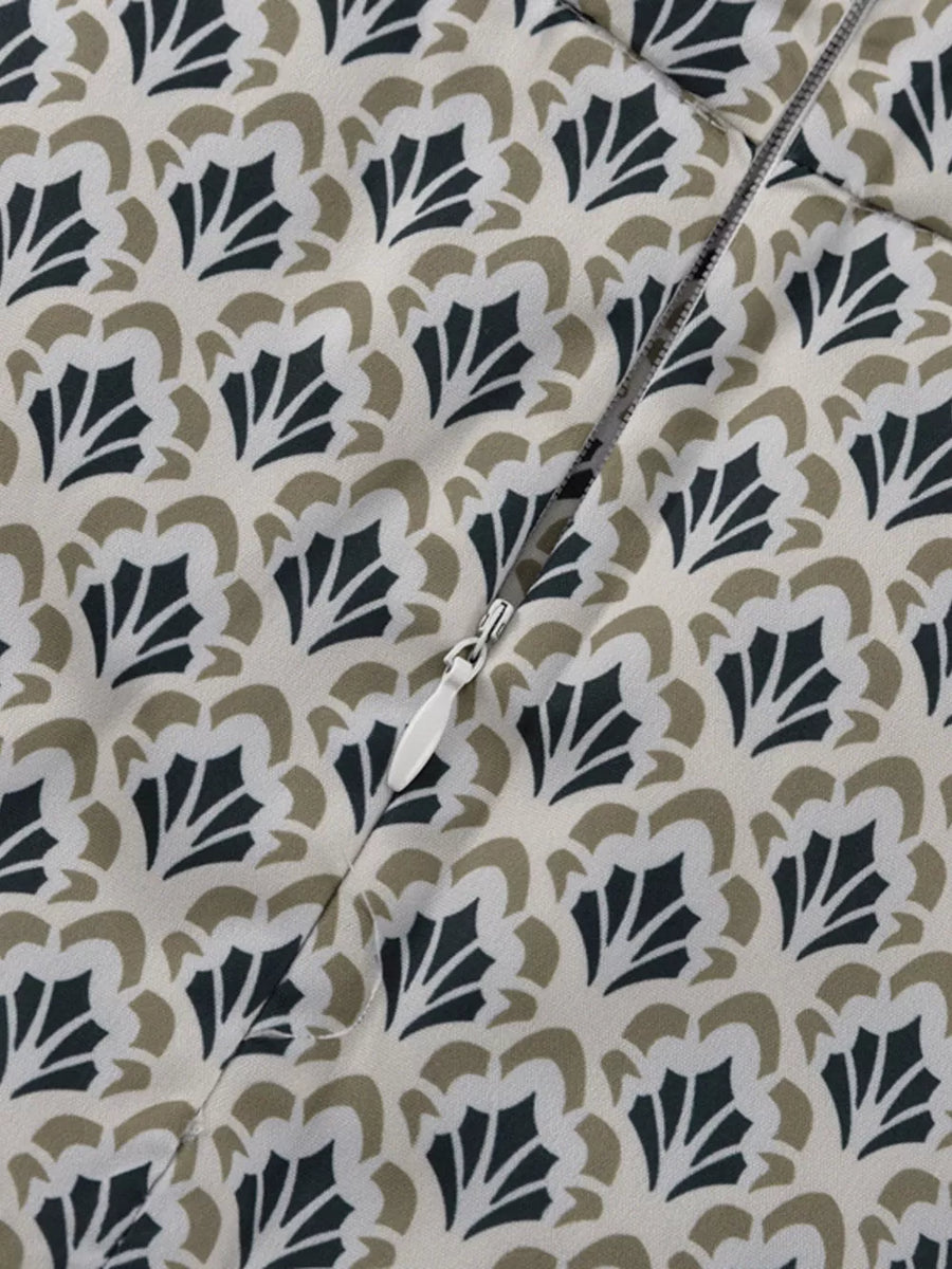 Dress with cream, black, and tan floral print and a white zipper.