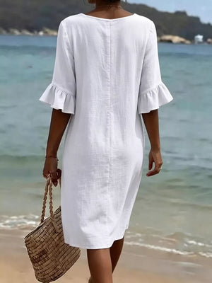 White casual dress with ruffled sleeves and button detail, perfect for beachwear.