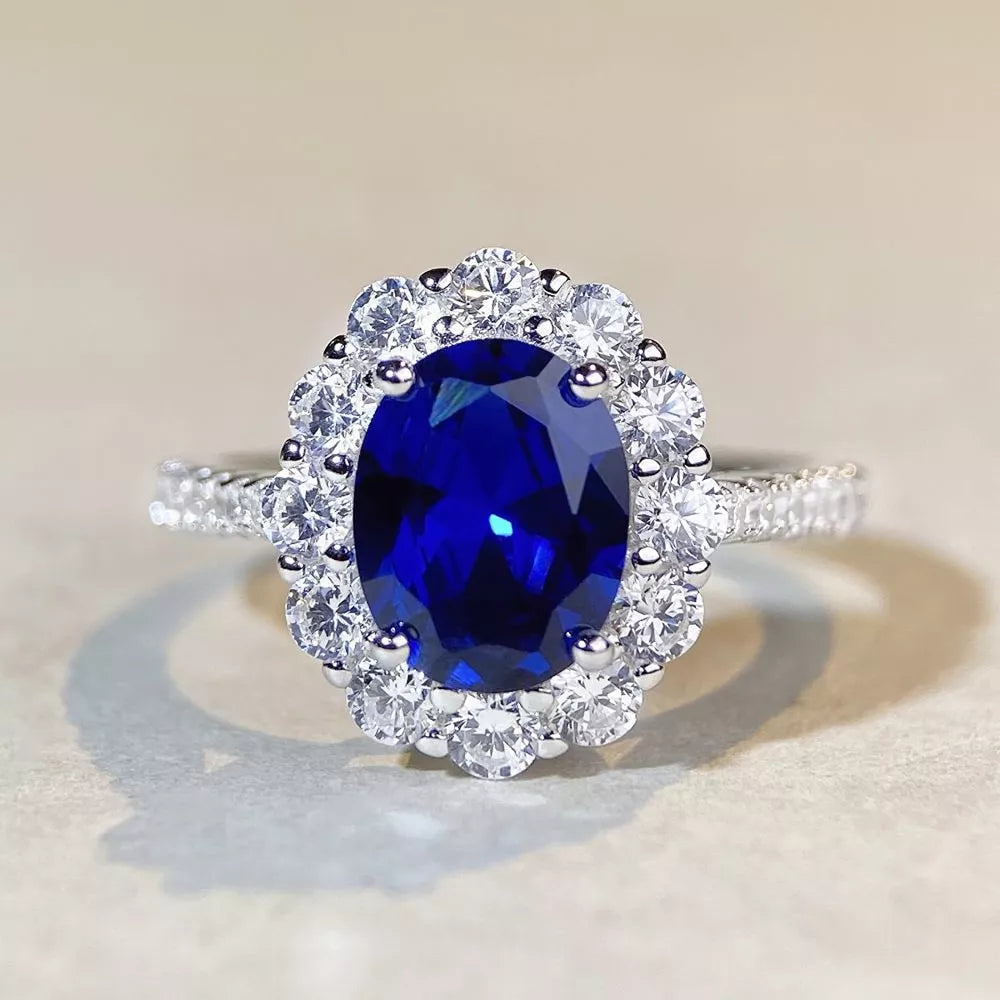 ring in sapphire blue with geometric and halo setting