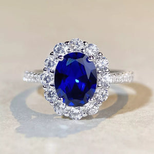 ring in sapphire blue with geometric and halo setting