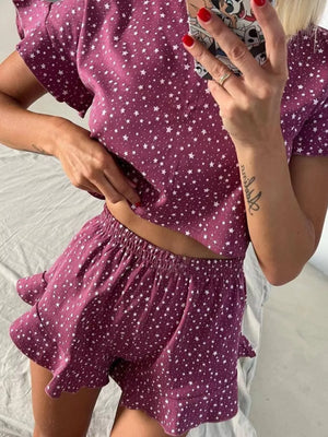 Purple star-print polyester pajama set with ruffled crop top and shorts.