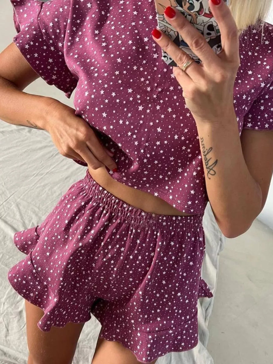 Purple star-print polyester pajama set with ruffled crop top and shorts.