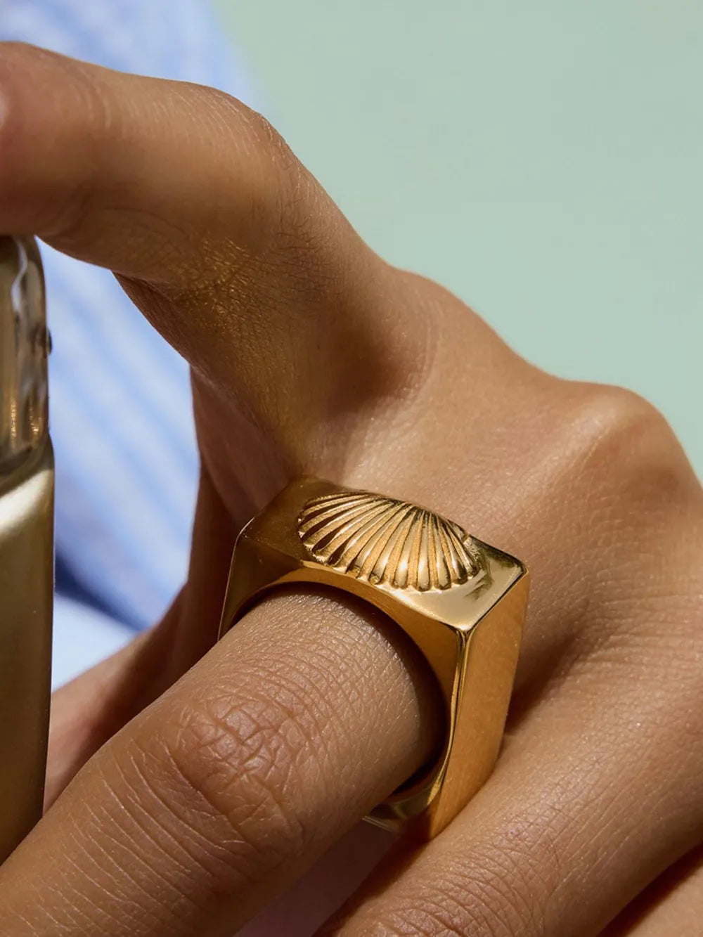 ring in gold featuring intricate shell pattern engraving and fitted fit