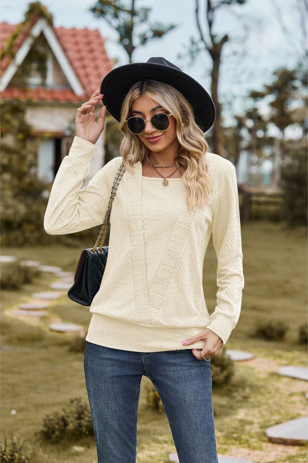 Textured knit sweater in ivory with a square neckline and long sleeves.