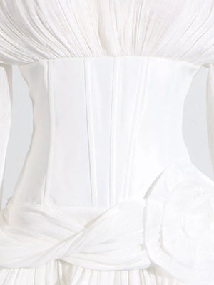 White ruffle mini dress with balloon sleeves, corset bodice, and floral detail.