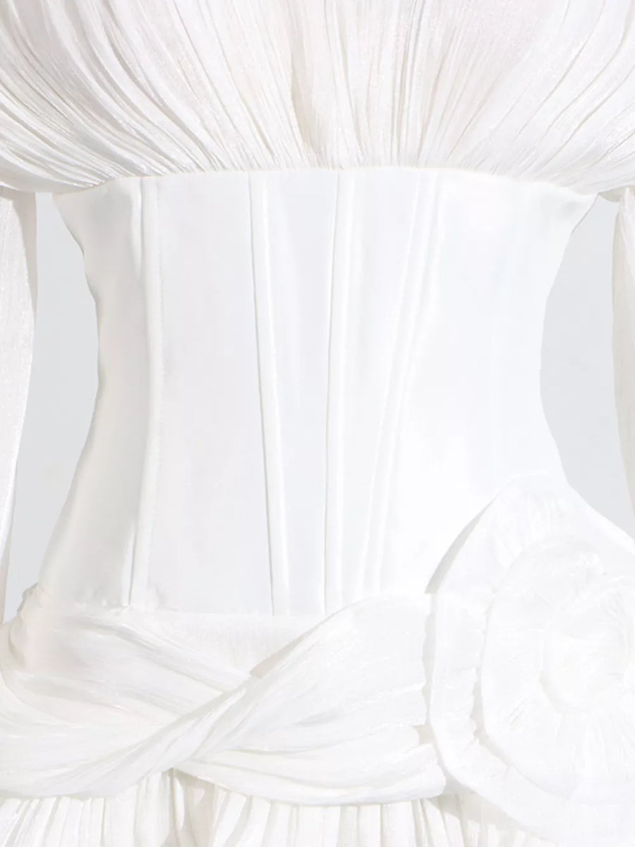 White ruffle mini dress with balloon sleeves, corset bodice, and floral detail.