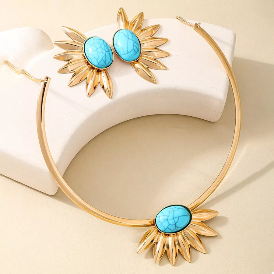 Gold sunflower jewelry set with turquoise stones, including a necklace and earrings.