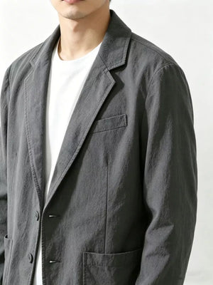 Men's grey long sleeve sport jacket with notched lapels and chest pocket.