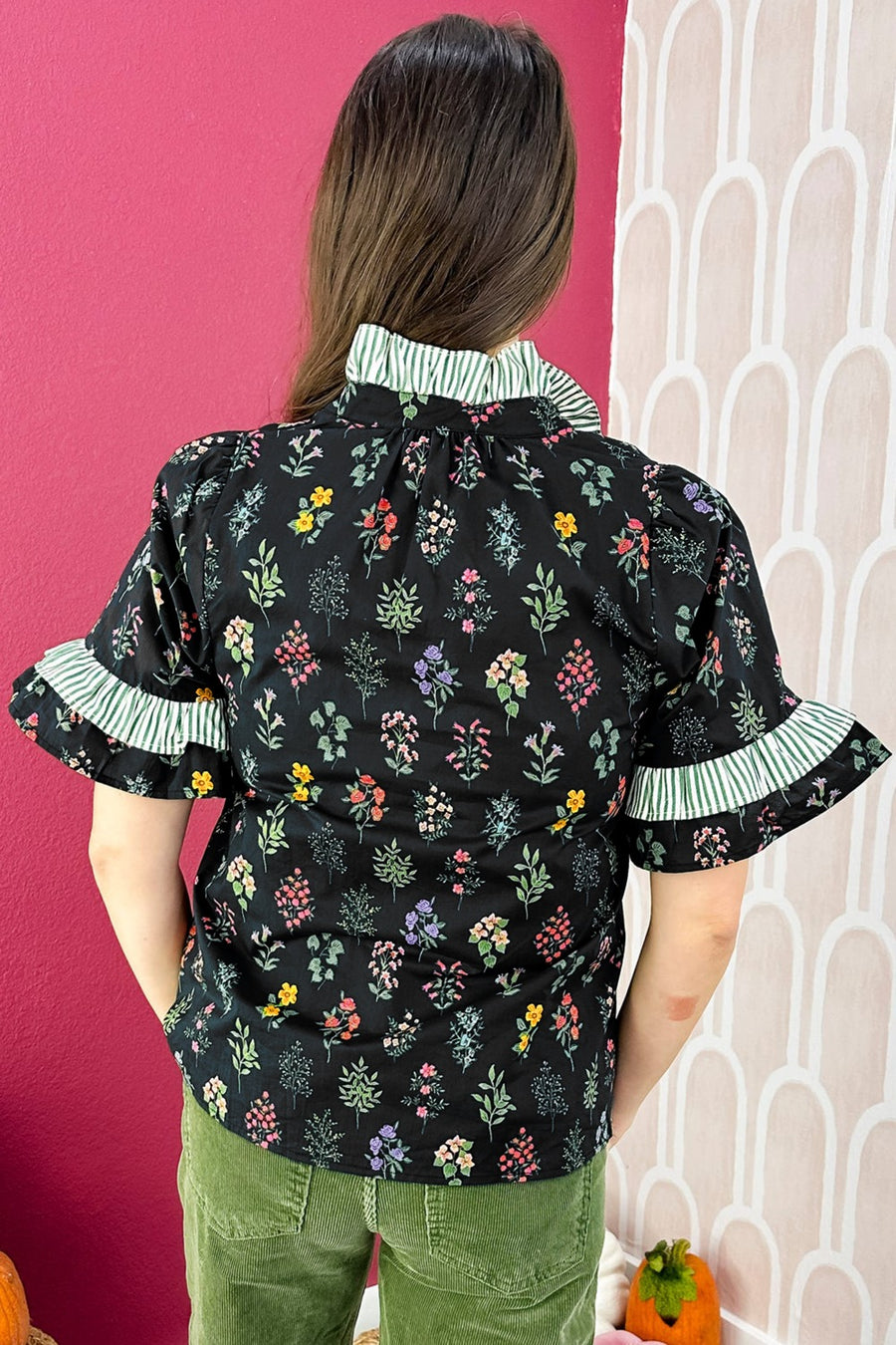 Black floral cotton blouse with ruffled short sleeves and striped collar.