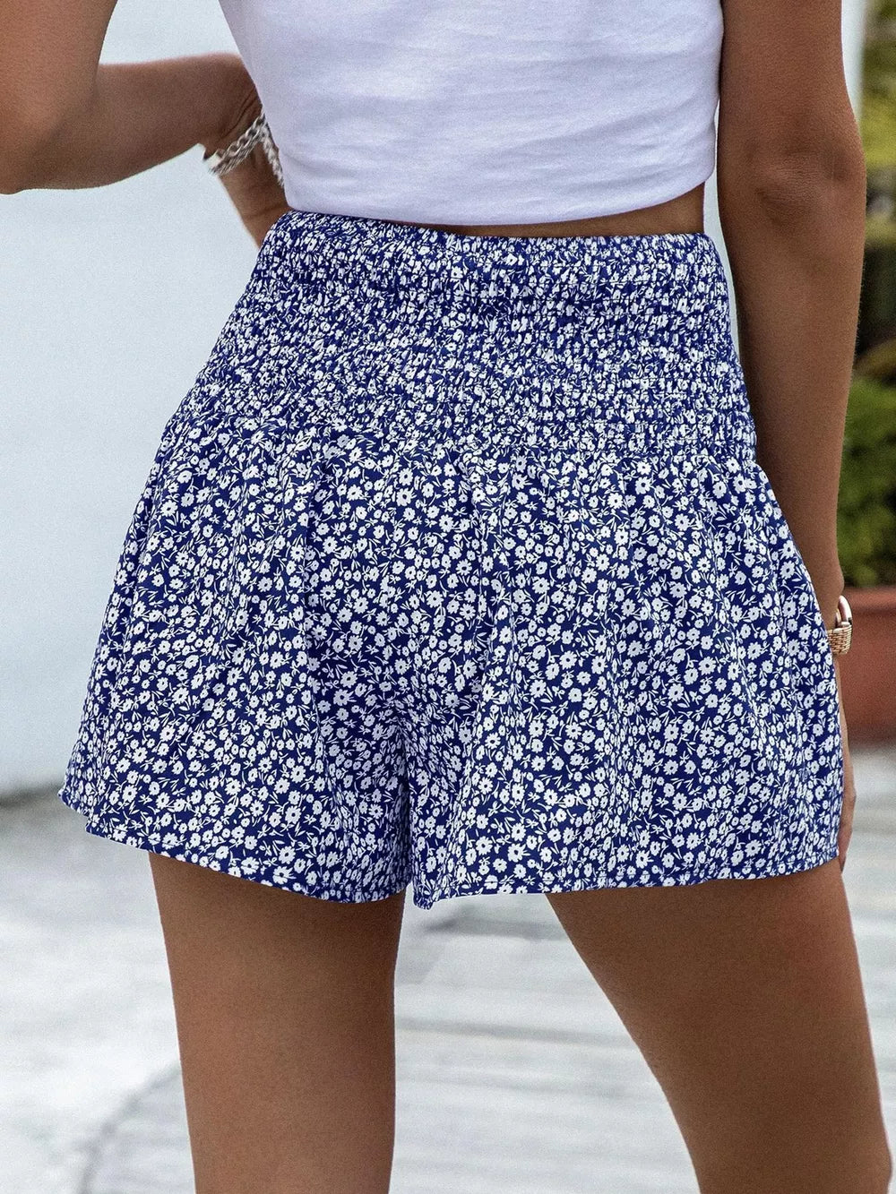 Blue floral chino shorts with elastic waist and ruffled hem