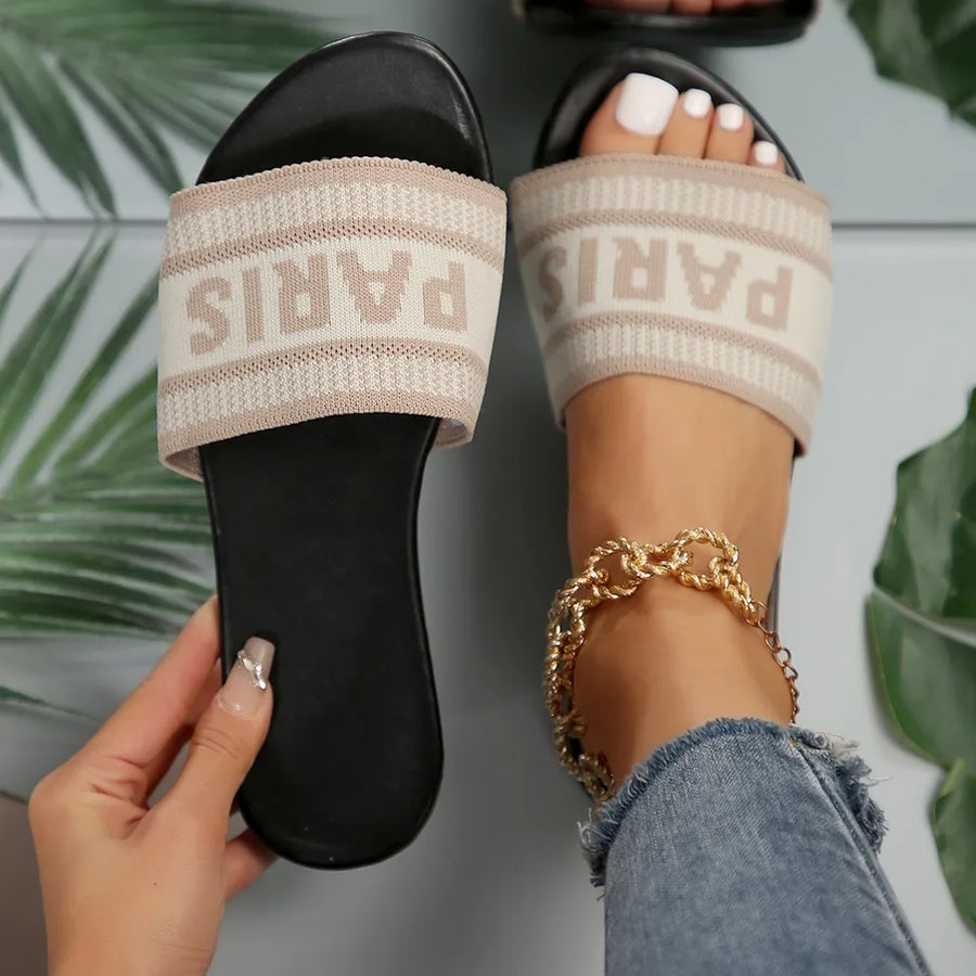 Parisian logo band slide sandals in beige with black sole.