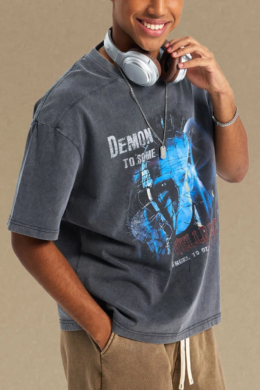 Relaxed fit dark gray graphic tee with "Demon to Some" text and blue character print.