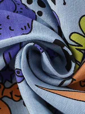 Light blue knit fabric with a playful cartoon graphic print featuring purple, orange, and yellow elements.
