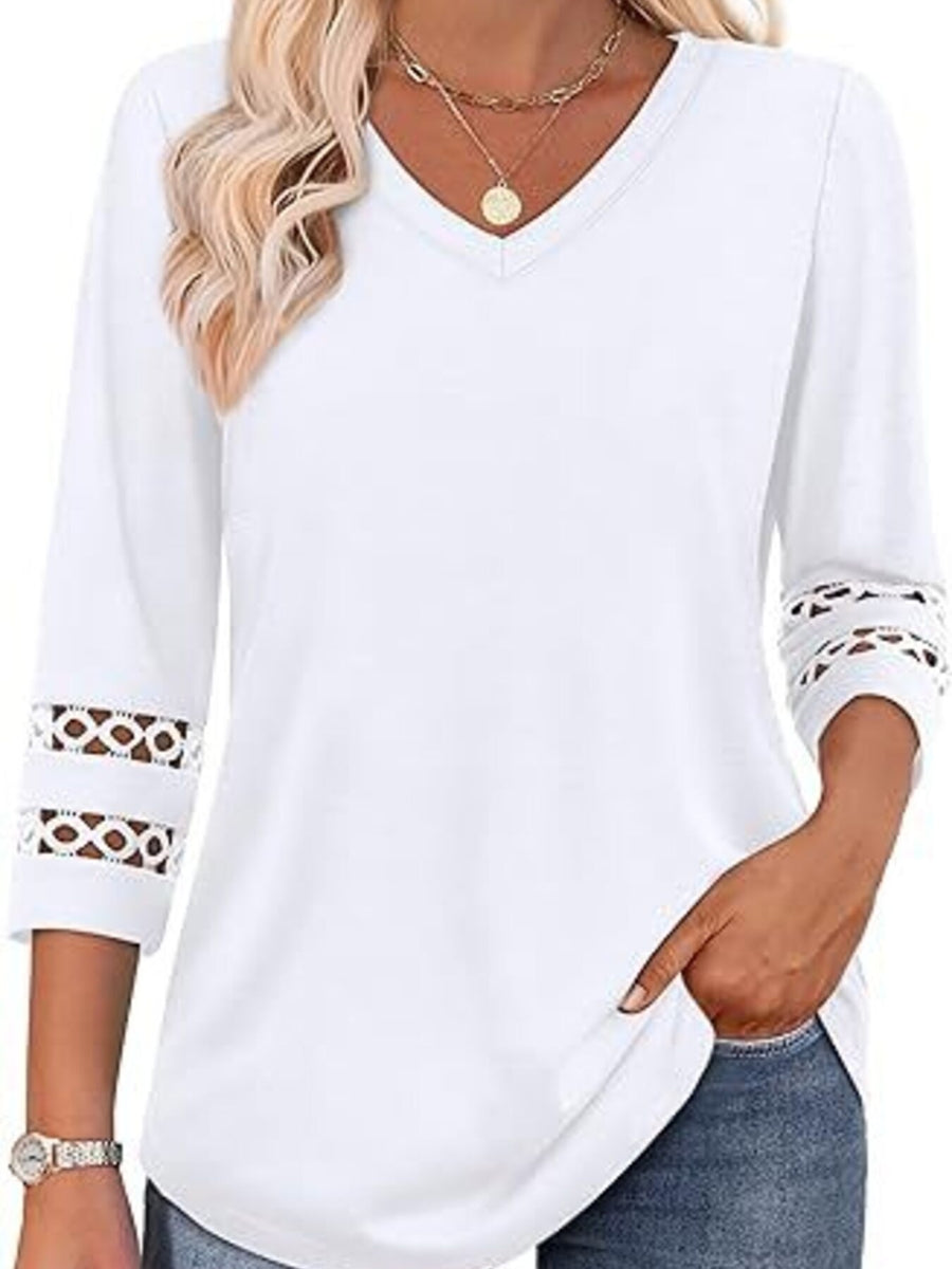 White 3/4 sleeve t-shirt with V-neck and cutout detail on sleeves.