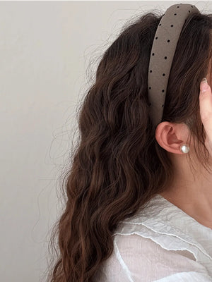 Padded polka dot headband in camel with black dots.
