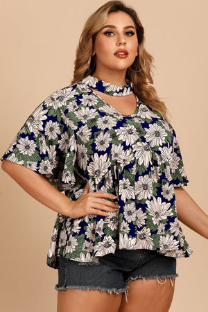 Dark blue floral peplum blouse with keyhole neckline and flutter sleeves.