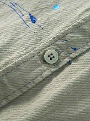 Sky Blue button-up shirt featuring buttoned and paint splatter