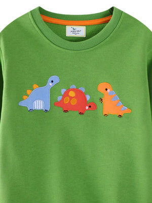 Green crewneck sweatshirt with three embroidered dinosaurs: blue, red, and orange.