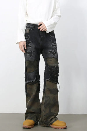 Distressed dark wash flare jeans with camo panels and ripped details.