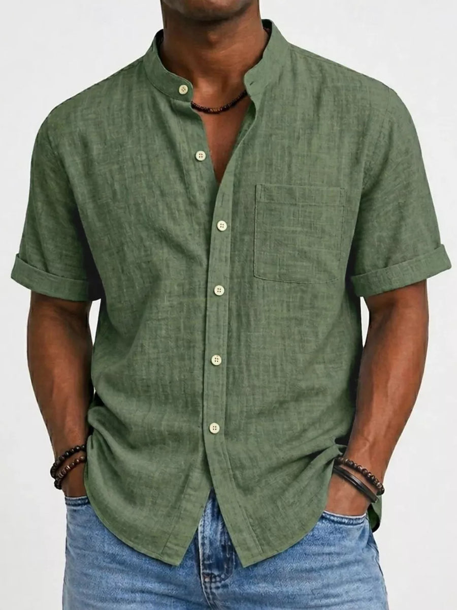 Army green textured cotton band collar short sleeve button-up overshirt with chest pocket.