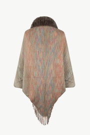 Textured knit cape with faux fur collar and fringe hem in a multicolor stripe pattern.