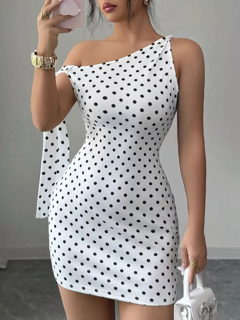 black mini dress featuring tied and polka dot