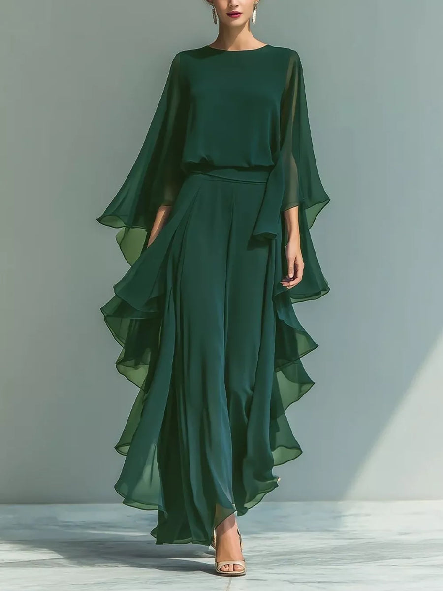 Green chiffon maxi dress with flowing cape sleeves and tiered ruffled skirt.