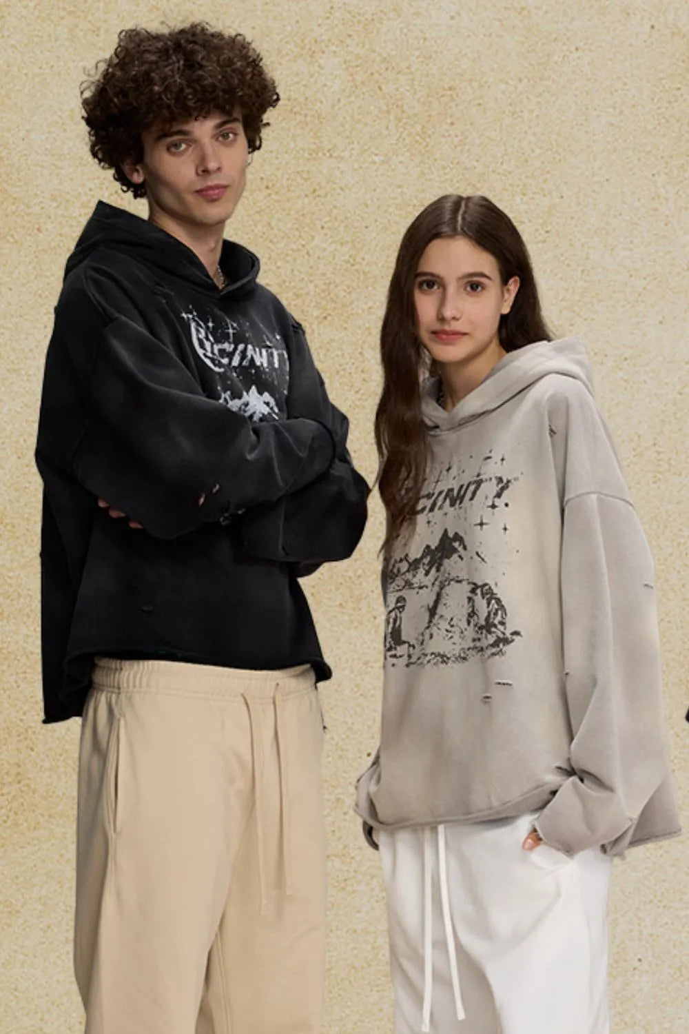 Distressed graphic oversized hoodie in black and gray with distressed details and a bold print.