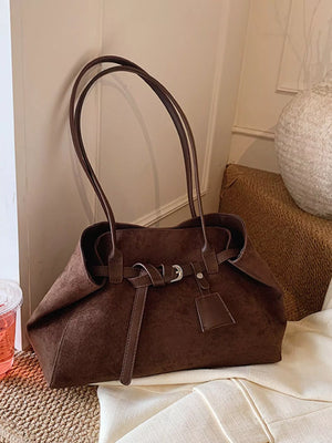 Brown suede shoulder bag with buckle detail and top handles