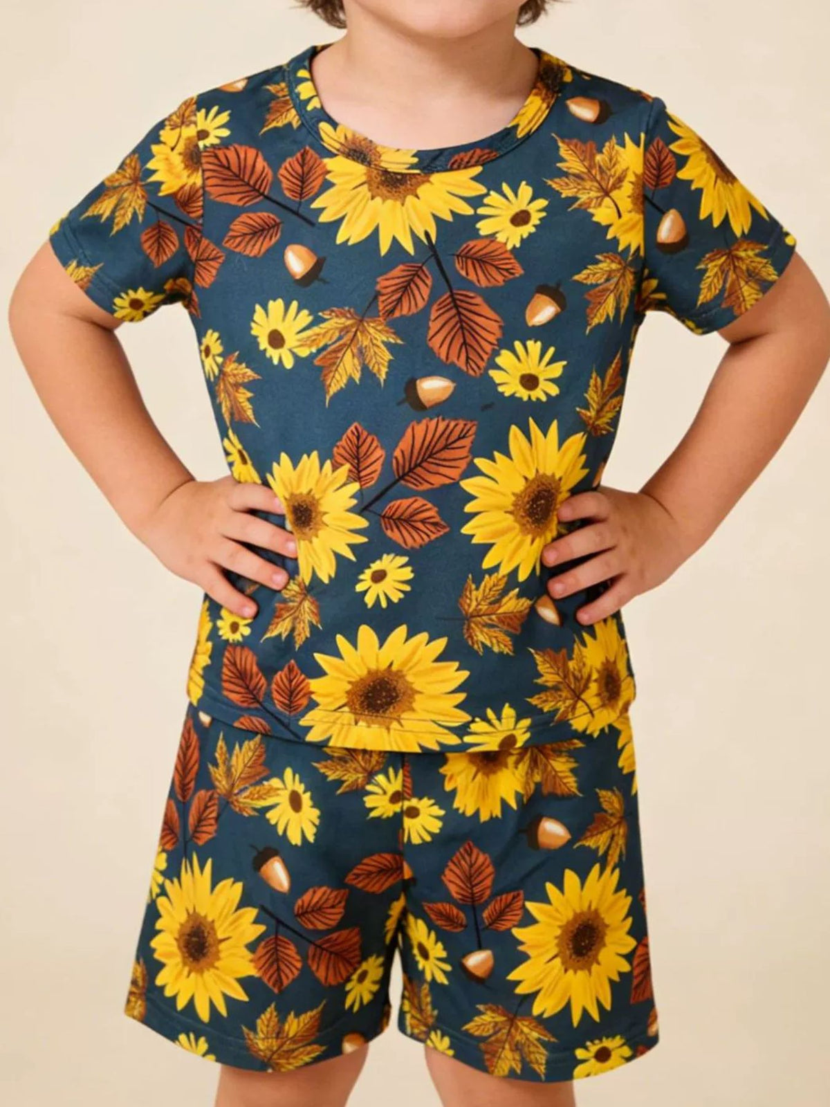 Toddler blue tee and shorts set with yellow sunflowers, brown leaves, and acorns pattern.