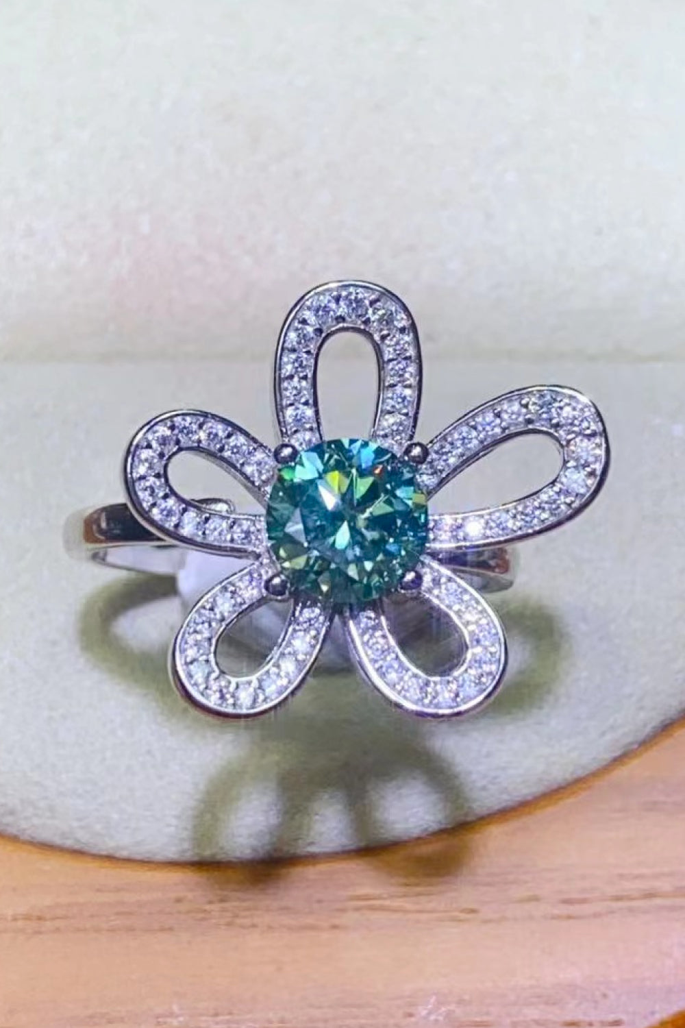 Teal moissanite flower ring with diamond accents