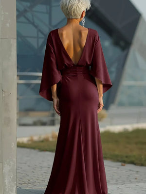 Sophisticated batwing sleeve maxi dress in deep red with a plunging V-back and cinched waist.
