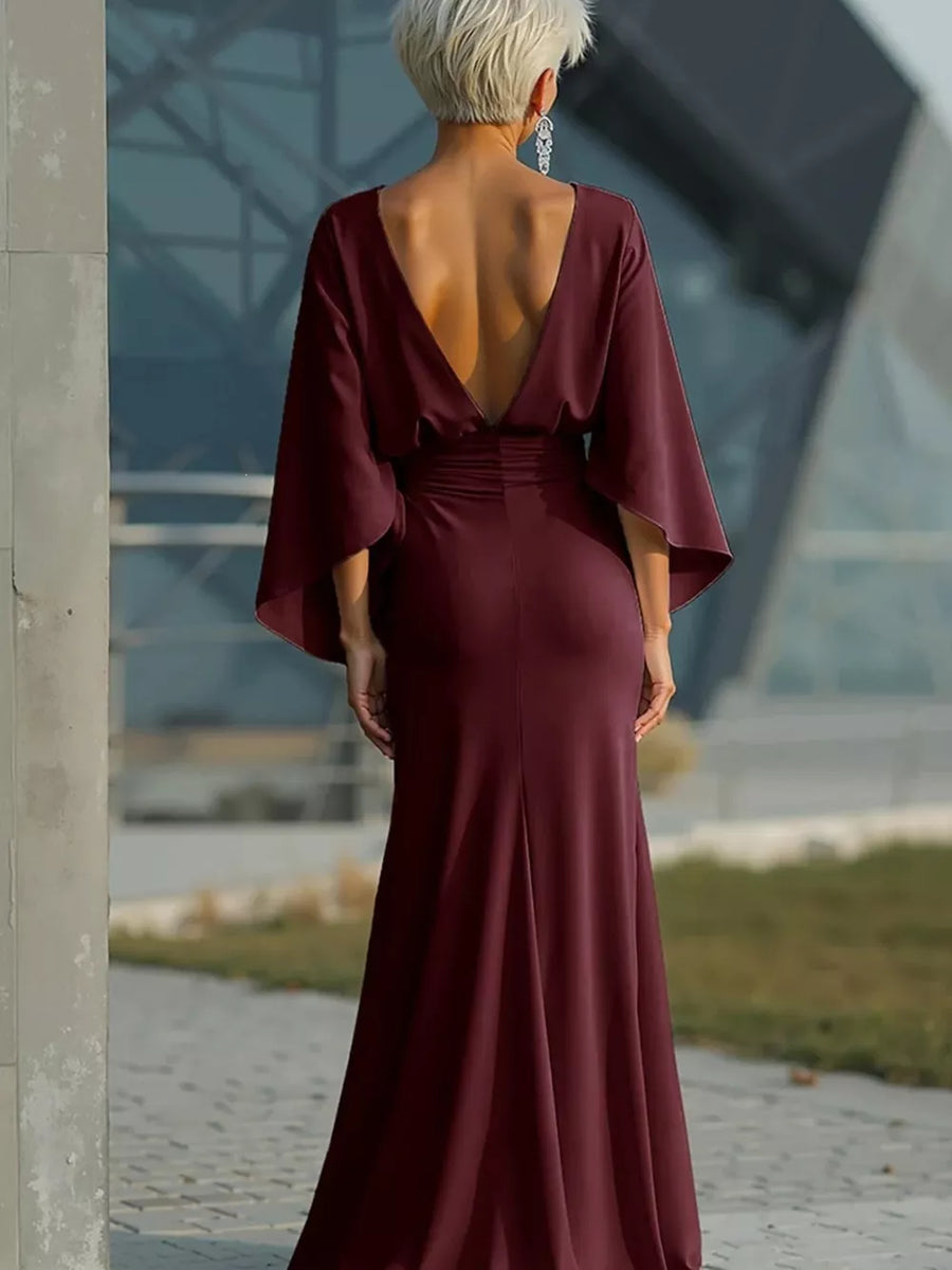 Sophisticated batwing sleeve maxi dress in deep red with a plunging V-back and cinched waist.