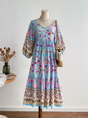 Plus-size light blue floral v-neck dress with tiered skirt and balloon sleeves.