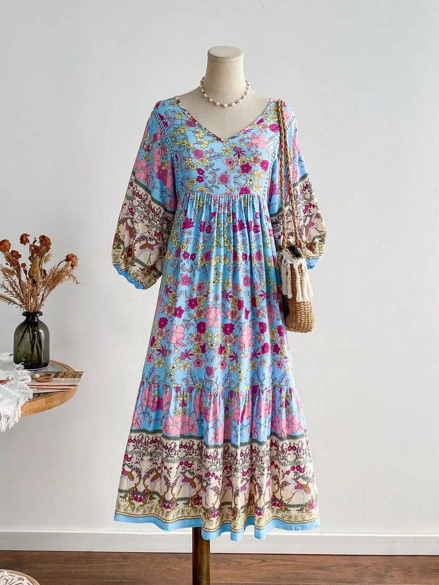 Plus-size light blue floral v-neck dress with tiered skirt and balloon sleeves.