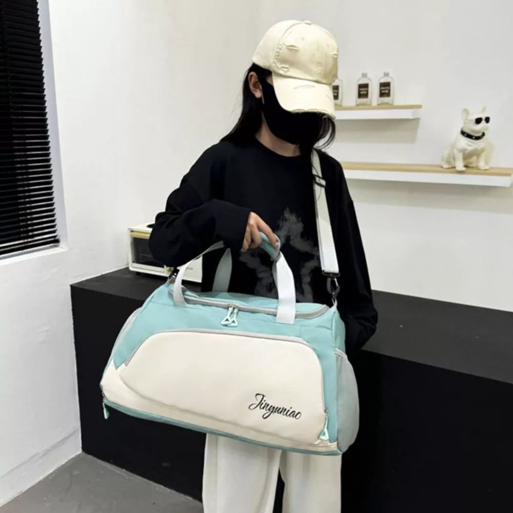 Medium waterproof duffel bag in light green and cream with pockets and a script logo.