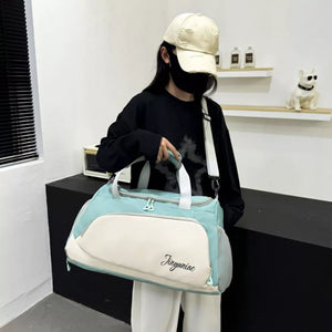 Medium waterproof duffel bag in light green and cream with pockets and a script logo.