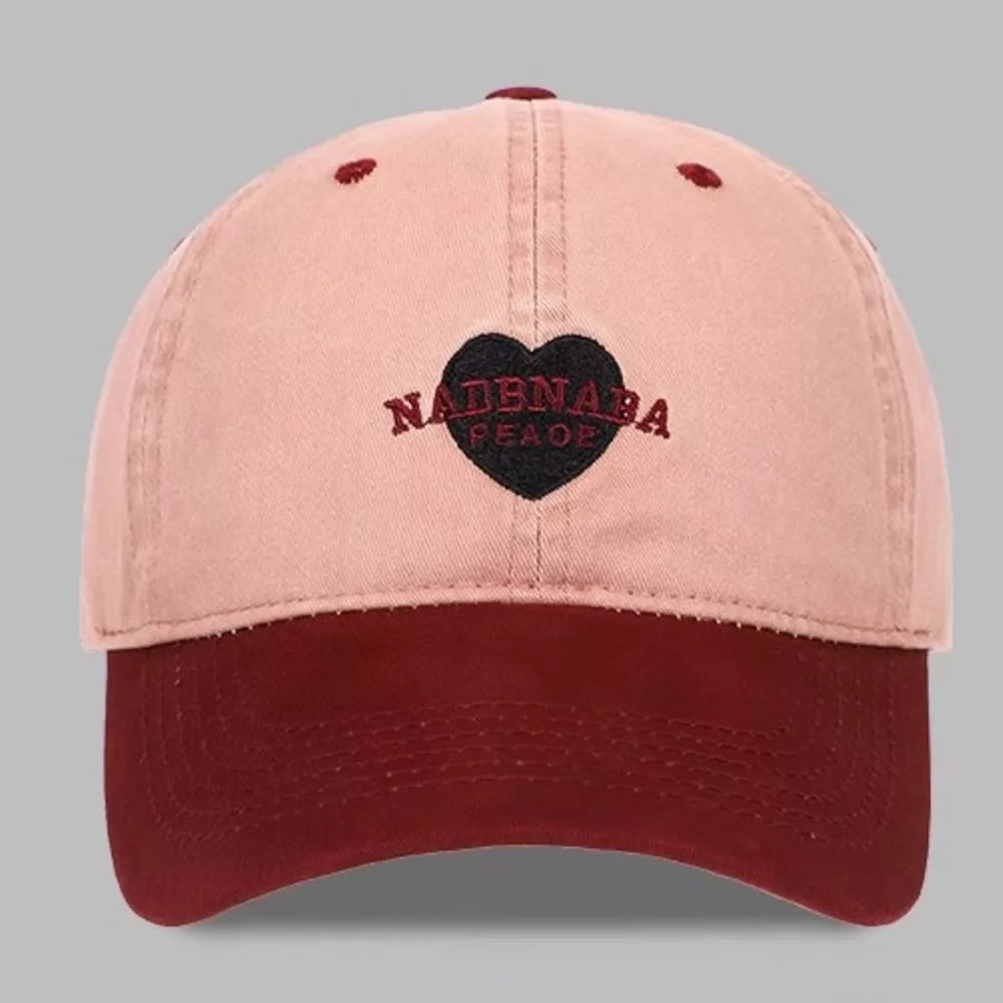 Blush pink and red-violet cotton baseball cap with embroidered heart detail
