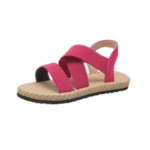 Hot pink crisscross elasticated summer sandals with tan woven sole.