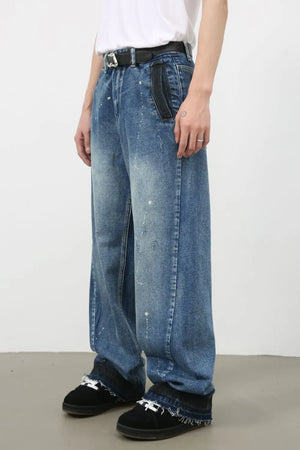 Panelled denim palazzo trousers in medium wash with paint splatters and wide leg.