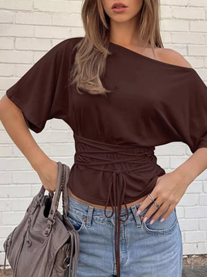 Brown draped tie-front short sleeve maternity t-shirt with dolman sleeves and asymmetrical neckline.