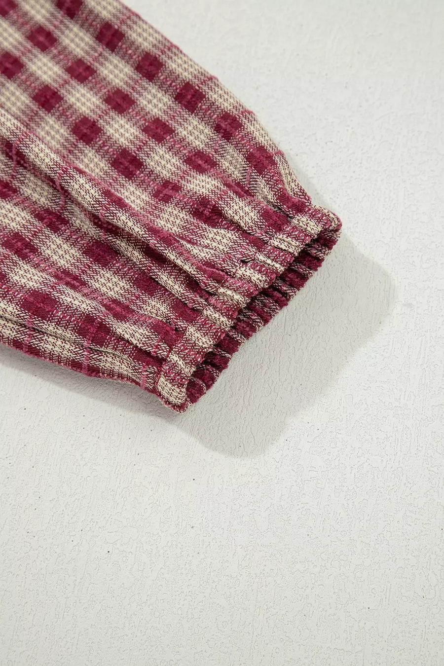 Country plaid long sleeve blouse in burgundy with elastic cuff detail.
