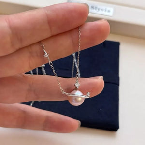 Celestial pearl and silver pendant necklace with diamond accents.